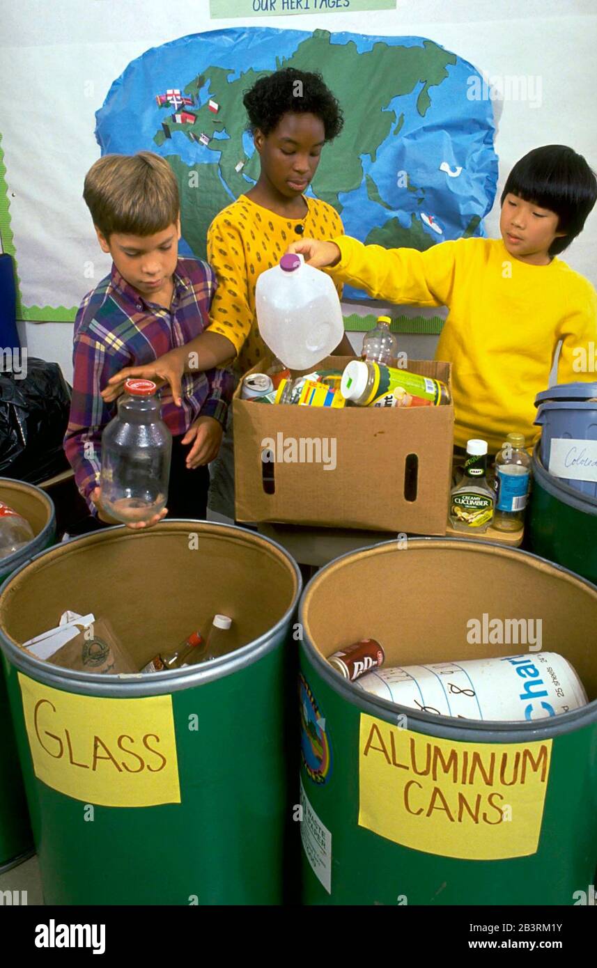 Austin Texas USA, circa 1988: Sixth-grade students sort trash into appropriate recycling bins in public school classroom. ©Bob Daemmrich Stock Photo