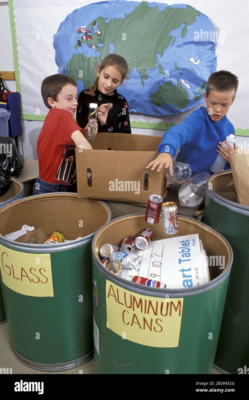 Austin Texas USA, circa 1988: Third-grade students sort trash into appropriate recycling bins in public school classroom. ©Bob Daemmrich Stock Photo