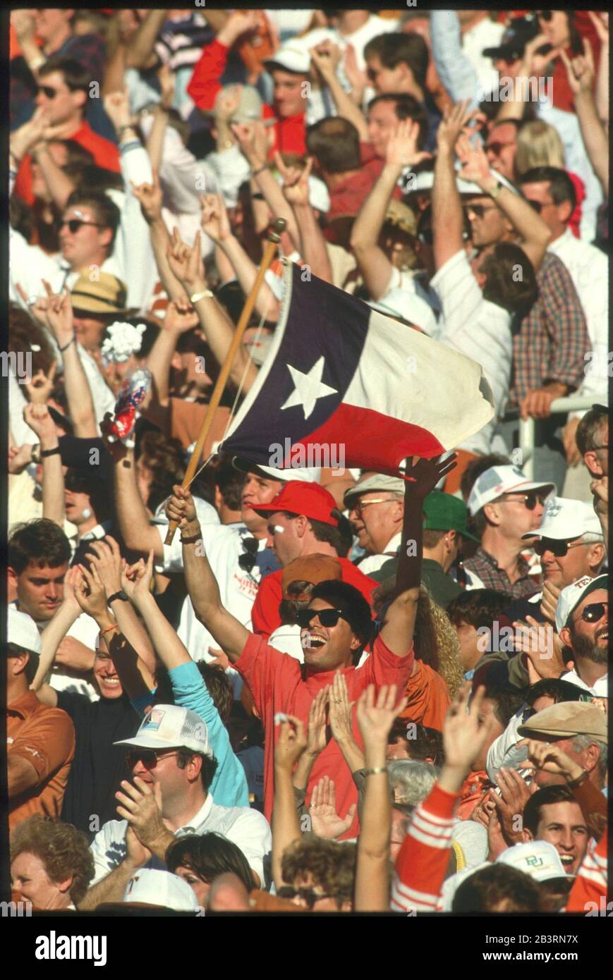 Waco Texas USA, circa 1993: Crowd of people cheering at college football game. Stock Photo