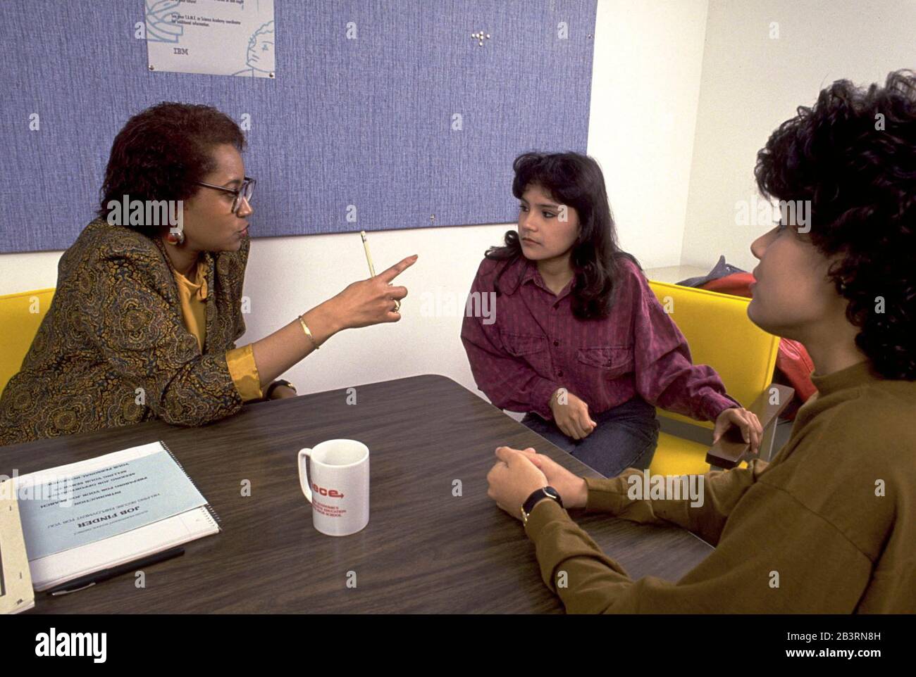 Austin Texas USA, circa 1990: Black female guidance counselor mediates disagreement between teenage girls at school.  MR   ©Bob Daemmrich Stock Photo