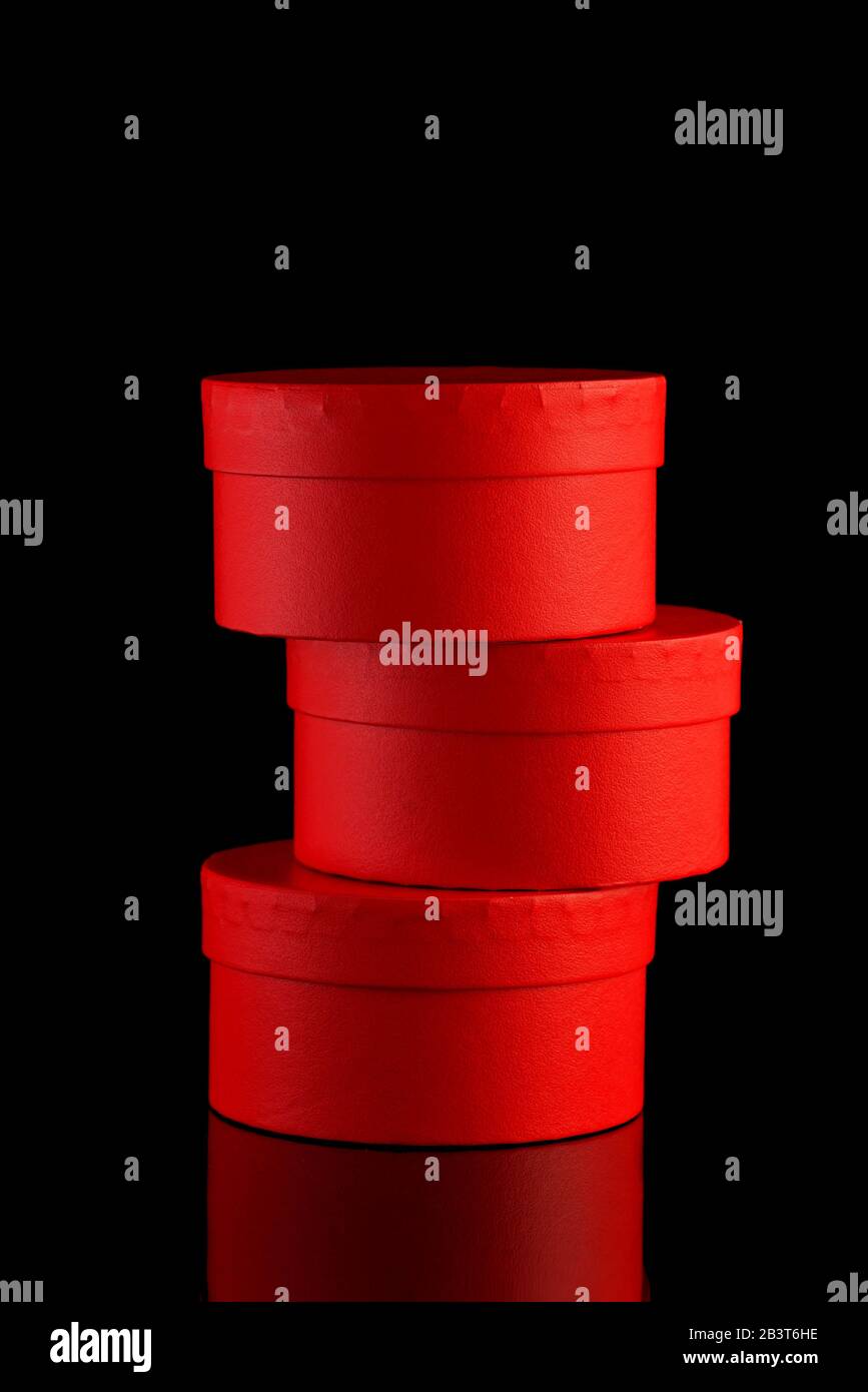 stand on each other three red gift boxes on black background, isolated ...