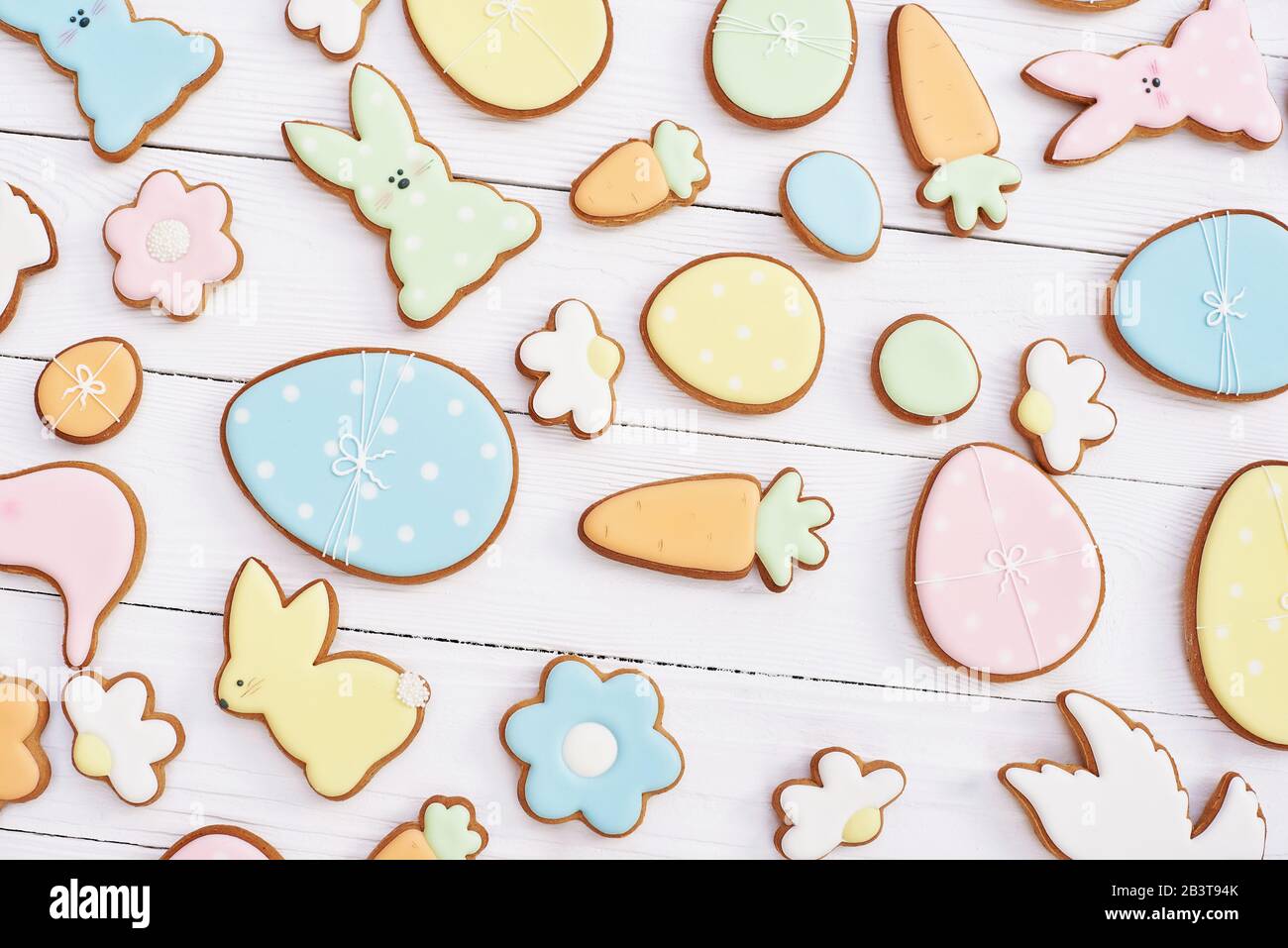 Easter greeting card with gingerbread cookies. Easter spring decorative composition with homemade easter cookies in shape of funny rabbit and eggs Stock Photo