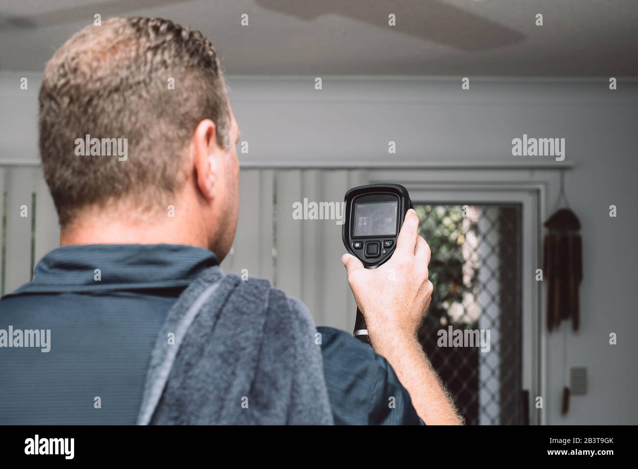 Male Pest Control Worker checking apartment with thermal imaging camera