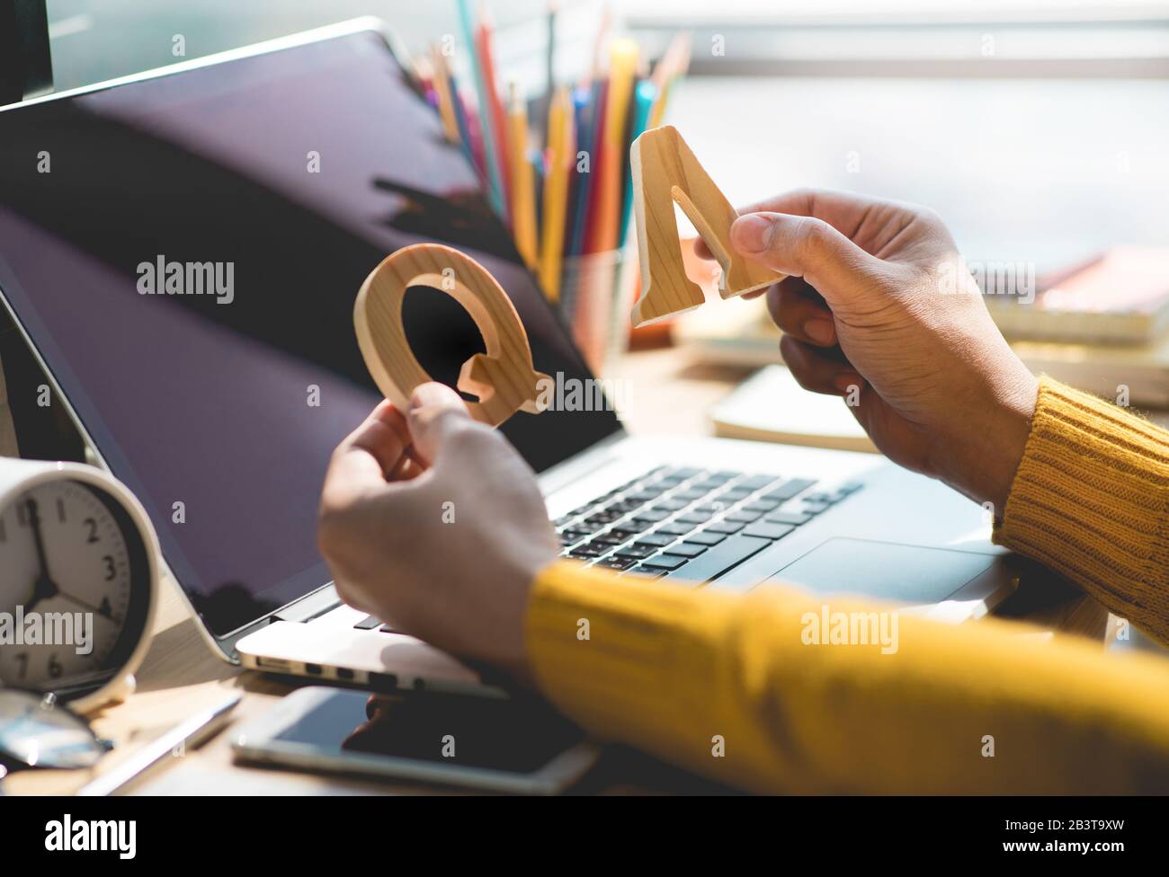 Selective focus / Q and A concepts with person holding mock up letter on desk table.business solution ideas Stock Photo