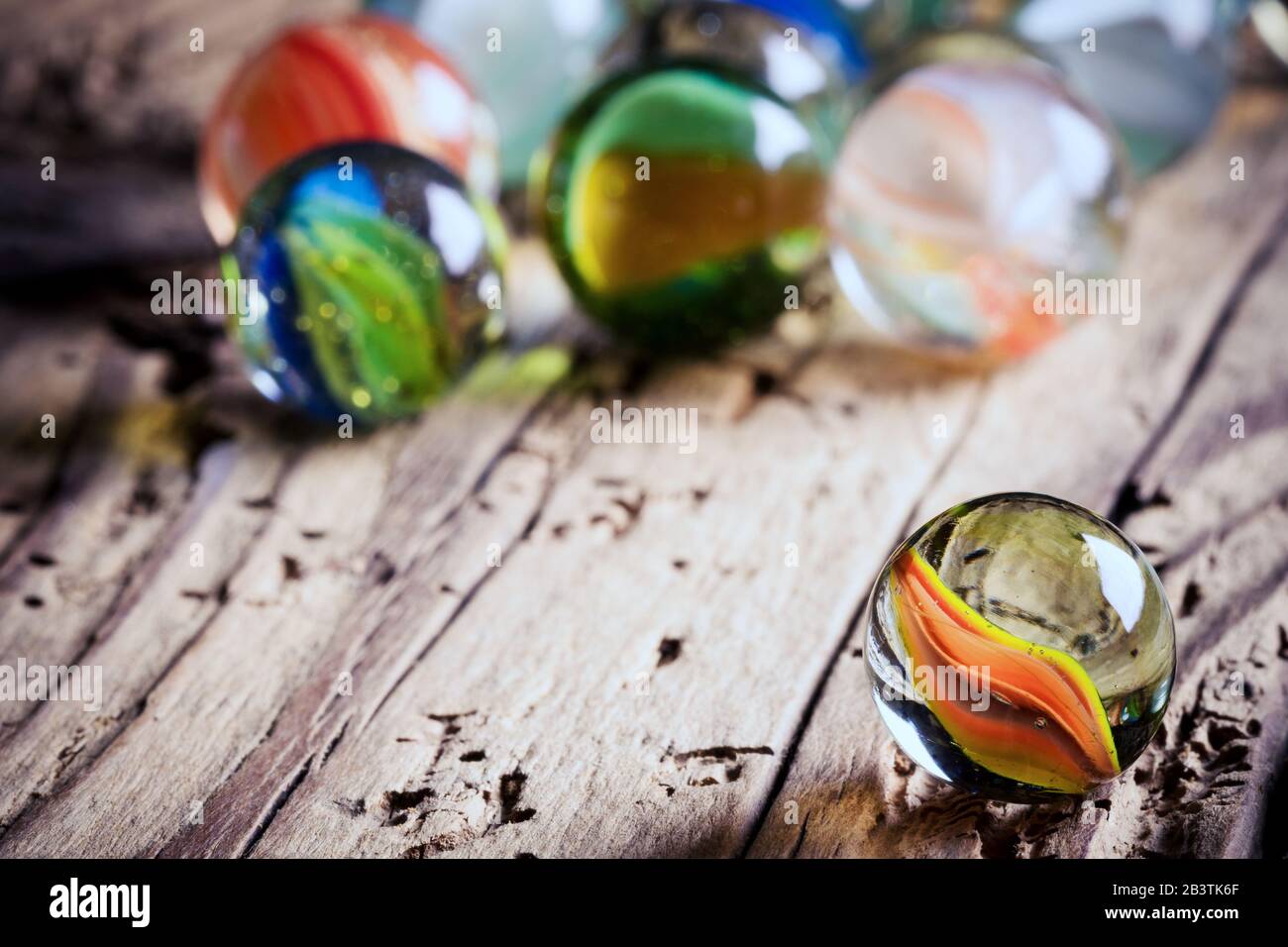 glass marbles on wood - close up Stock Photo