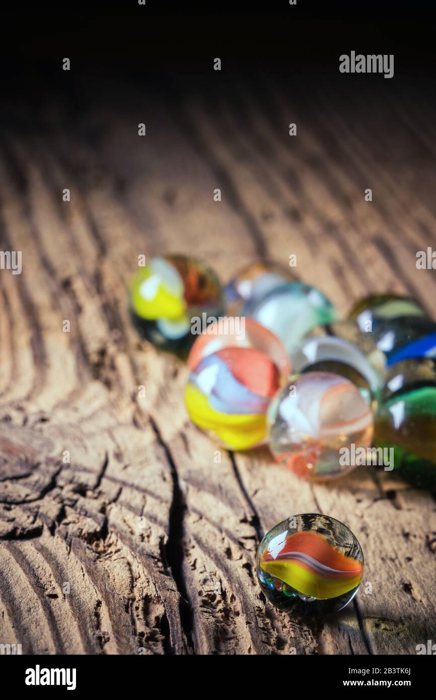 glass marbles on wood - close up Stock Photo