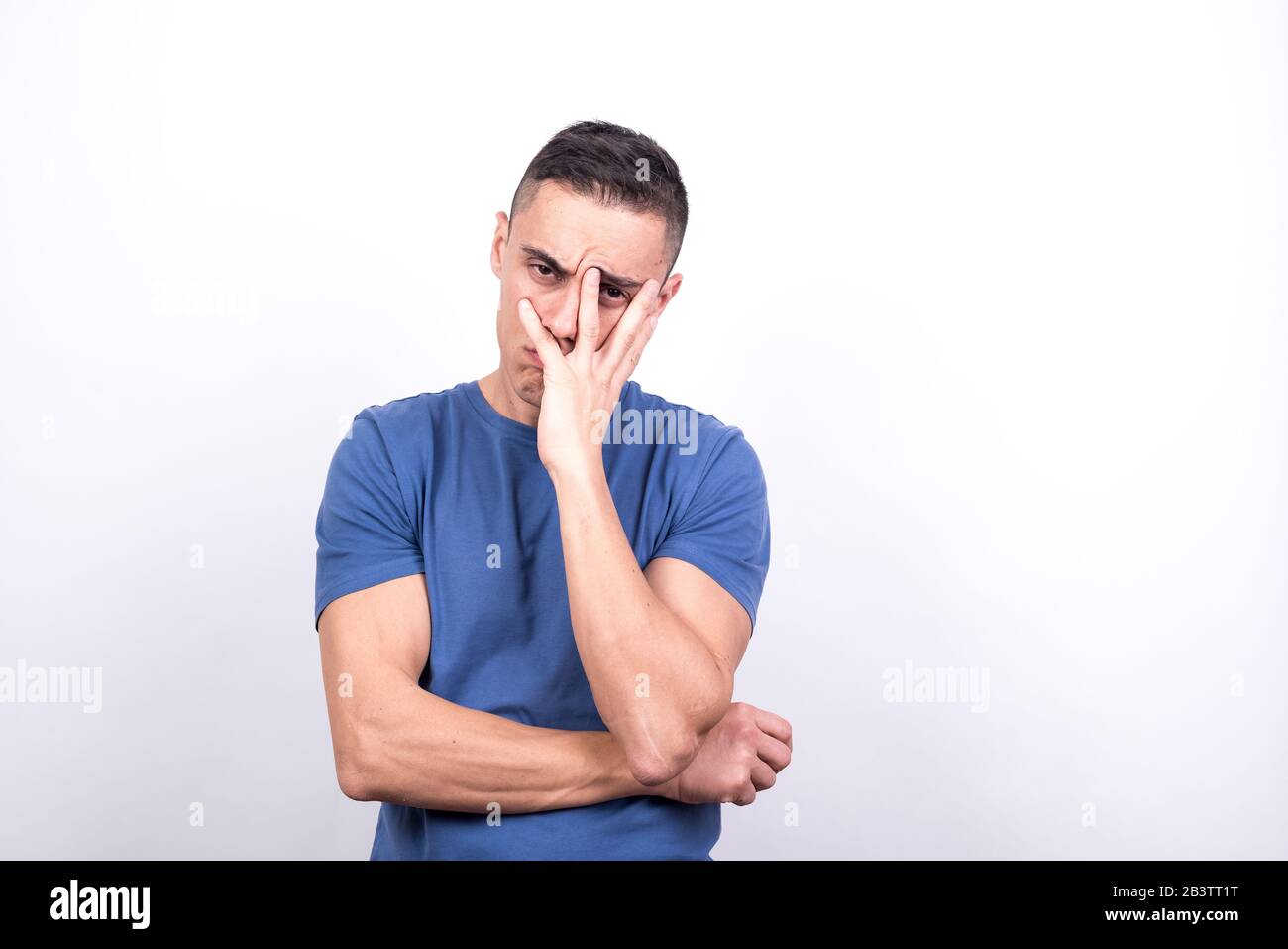 Bored man on white background, medium shot Stock Photo