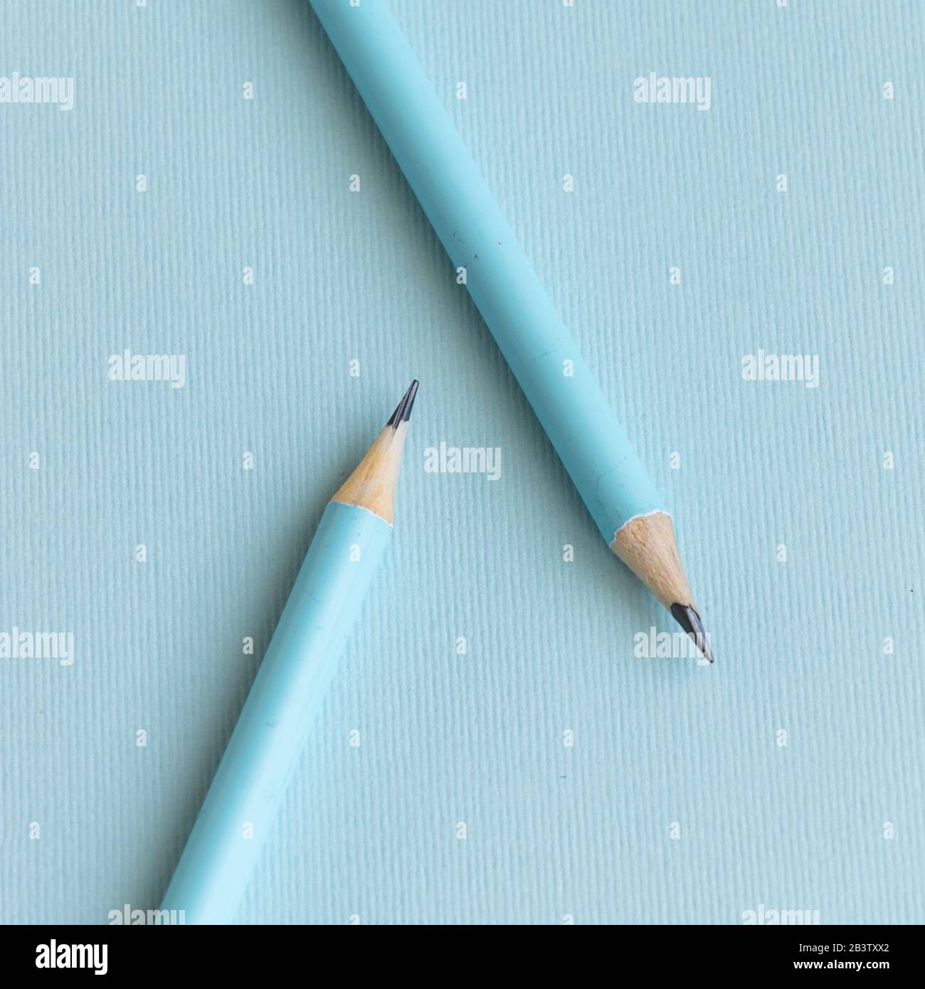 Pastel colored pencils on empty sheet, blue toned Stock Photo