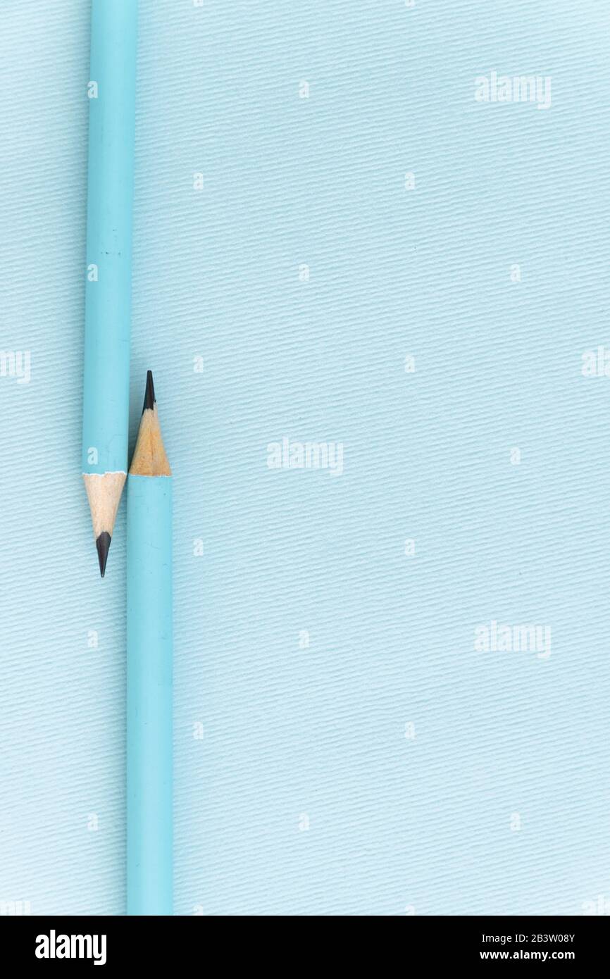 Pastel colored pencils on empty sheet, blue toned Stock Photo