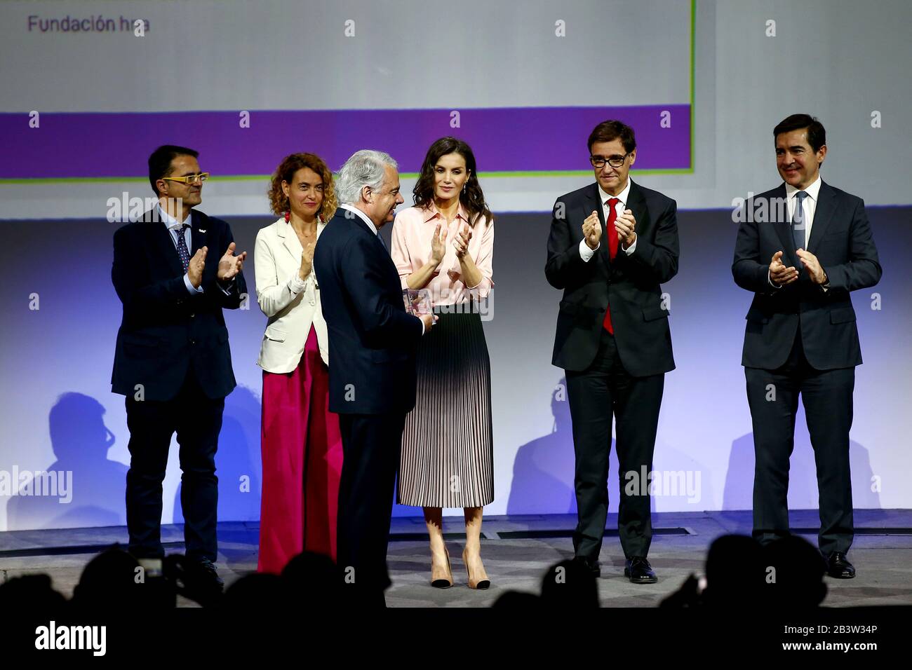 Madris, spain, 05/03/2020.- Ignacio Garralda, president of the Mutua Madrilena Foundation, receives the recognition of the Feder for his support for the therapies of children with rare diseases.Queen of Spain Letizia (C), together with the Minister of Health, Salvador Illa (2R), presides over the central act of World Rare Disease Day, which is celebrated with the motto 'Grow with you, our hope'. In the city of BBVA in Madrid with the assistance of the president of the Congress, Meritxell Batet (2L); the Spanish Federation of Rare Diseases (Feder in Spanish), Juan Carrión (L), and that of BBVA, Stock Photo