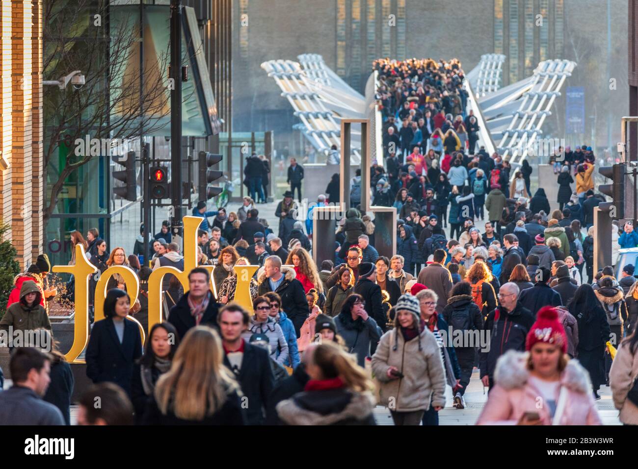 Millennium Bridge London - Tourists and commuters cross the Millennium Bridge from the Tate Modern Gallery Stock Photo