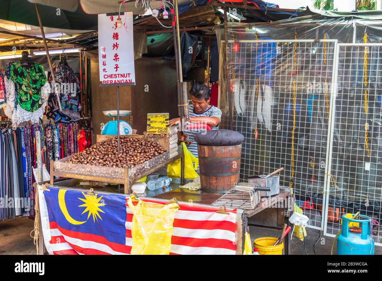 Local man selling roasted chestnuts in the Chinatown street market, Kuala lumpur, Malaysia, Asia Stock Photo