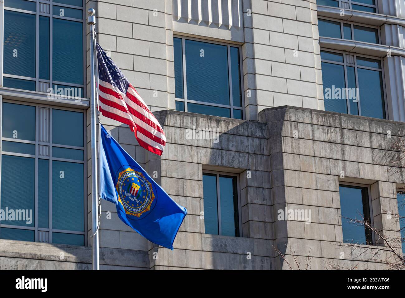 December 12, 2019: Seal of the FBI on a flag and American flag waving at their field office in D.C. Stock Photo
