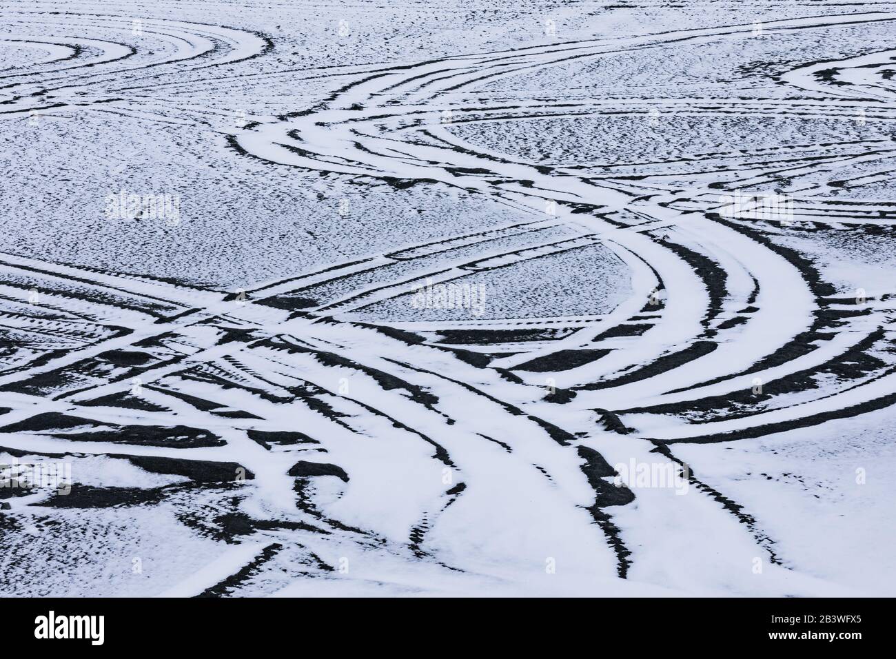 Vehicle tracks in snow-covered sand just off the road to Cape Race Lighthouse, Newfoundland, Canada Stock Photo