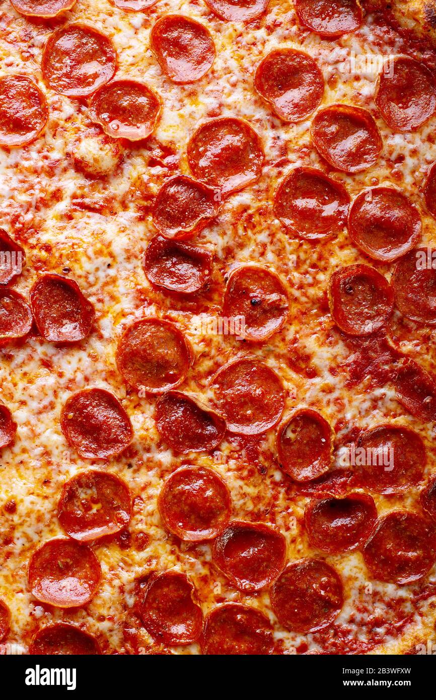 Pepperoni pizza surface close up food background Stock Photo - Alamy