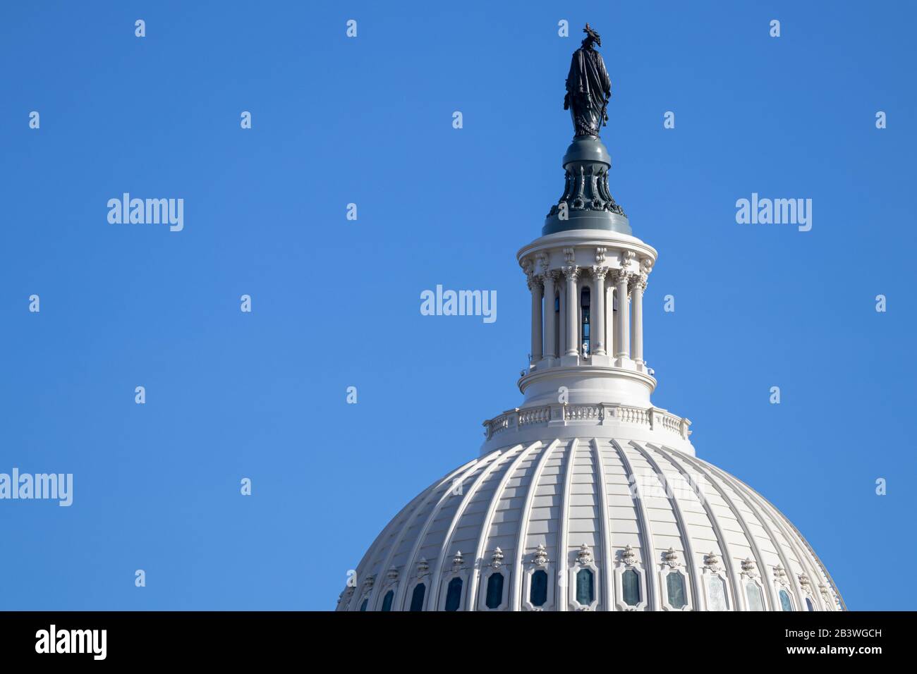 Closeup of US Capital Building Dome with the back of the bronze Statue of Freedom seen on clear day. Stock Photo