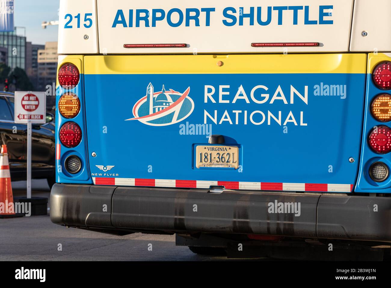Reagan Washington National Airport logo on the back on an airport shuttle while stopped at a Terminal. Stock Photo