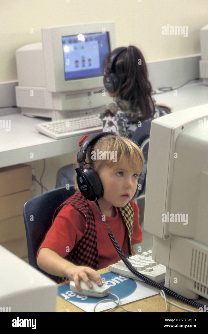 Kindergarten kids using computers hires stock photography and images