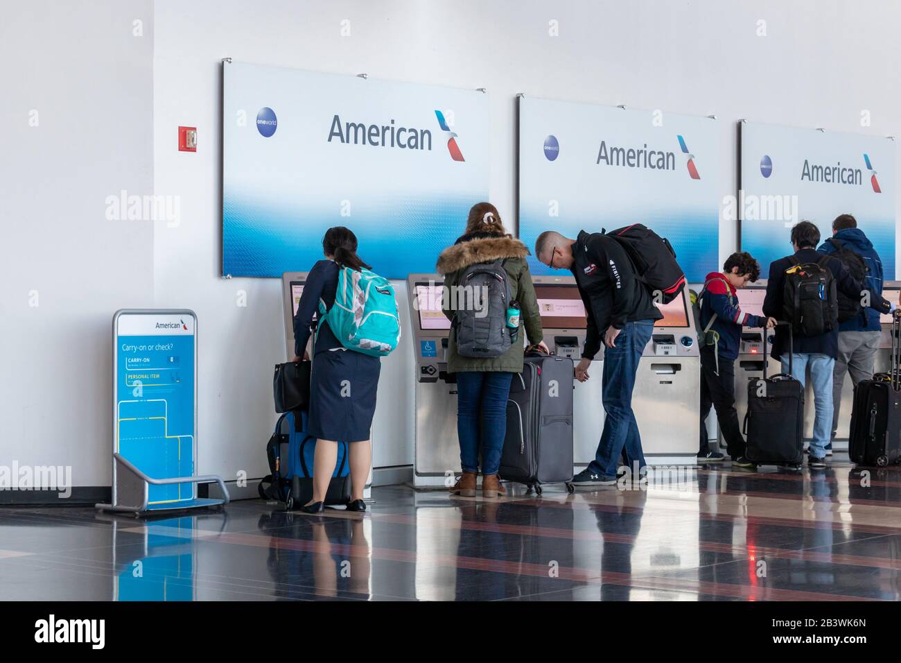 People seen using self-serve check-in kiosks for American Airlines inside Ronald Reagan Washington National Airport. Stock Photo