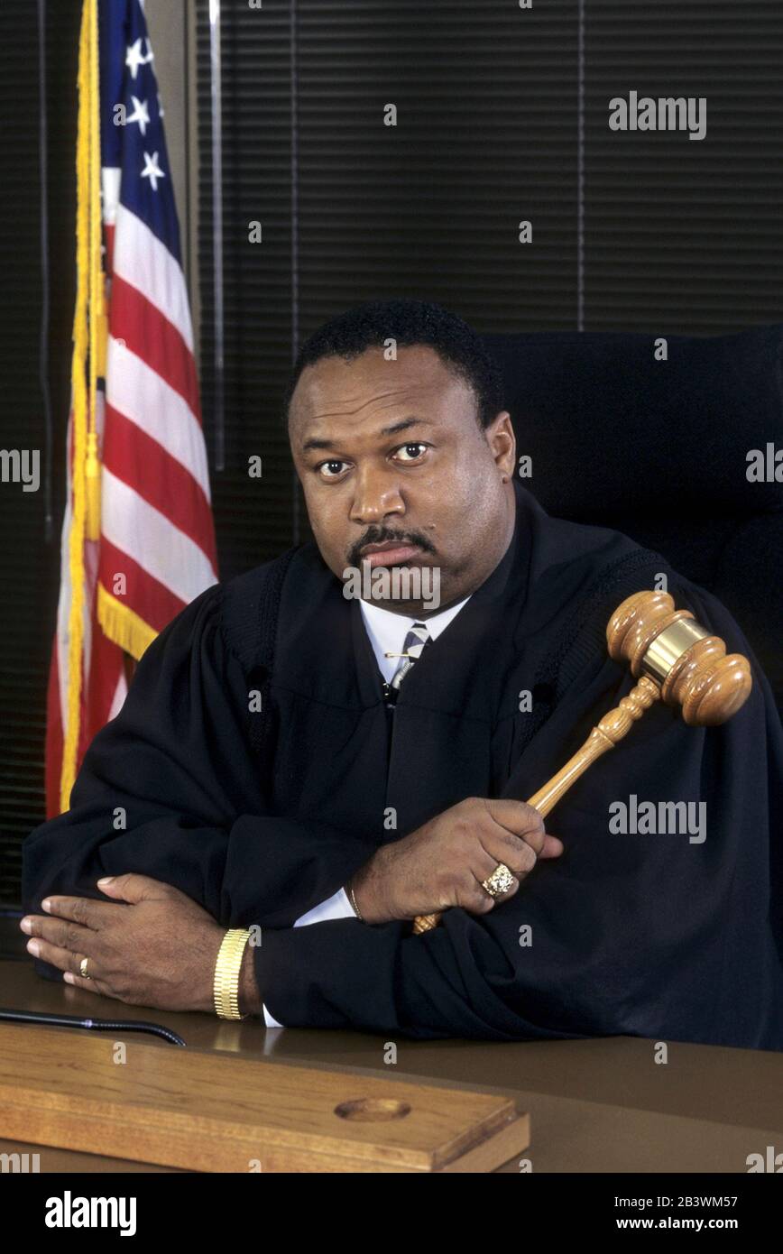 Austin Texas USA: African American judge in black robe holding gavel in courtroom. MR ©Bob Daemmrich Stock Photo