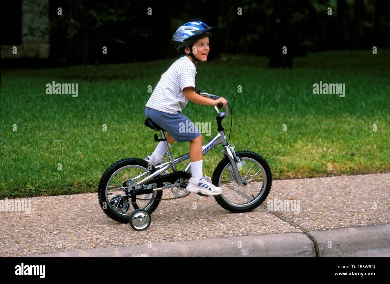 Austin, Texas Fiveyearold boy wearing a helmet safely riding his first bike with training