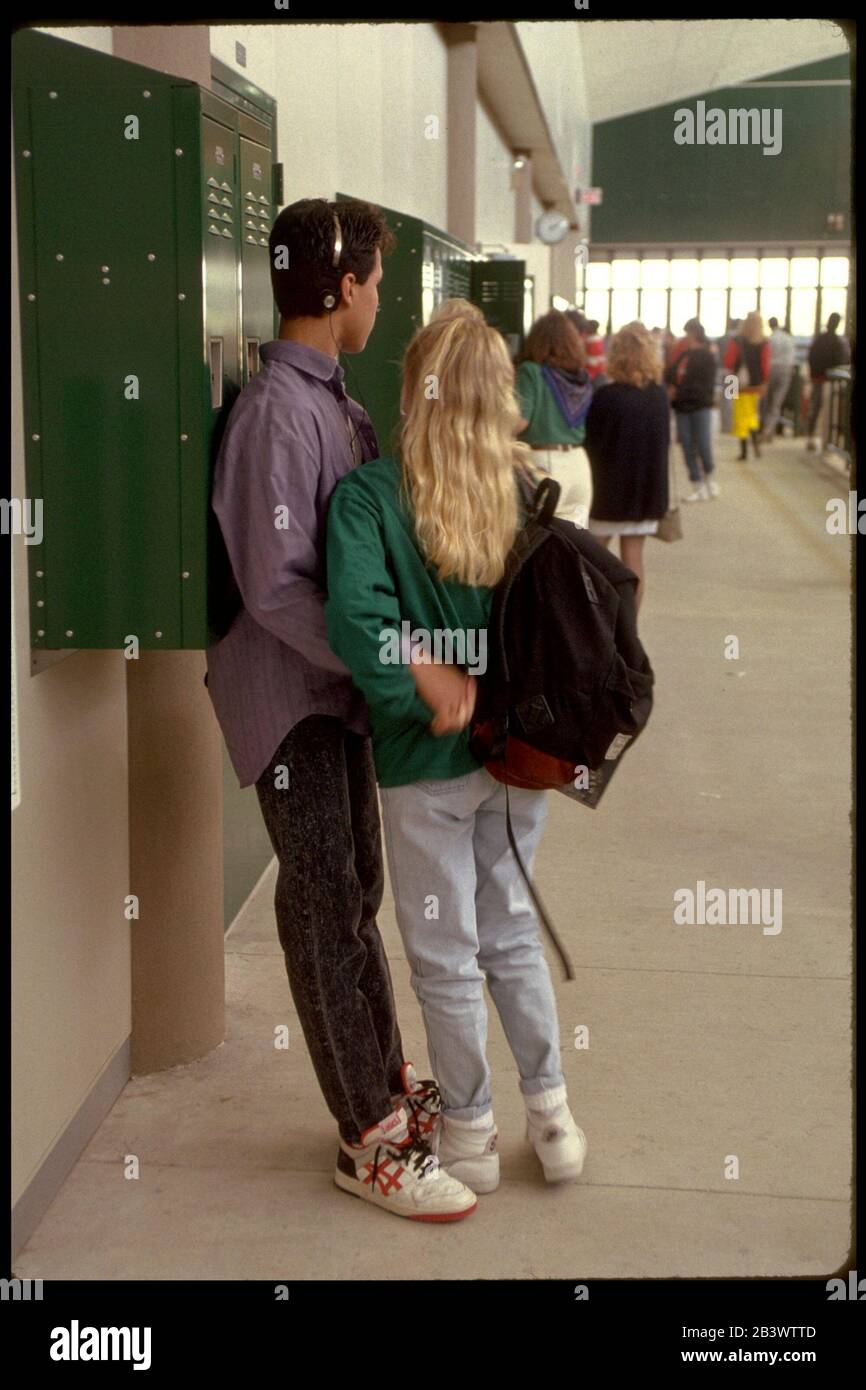 Austin, Texas USA: Couple snuggles together at lockers between classes at Bowie High School. ©Bob Daemmrich Stock Photo