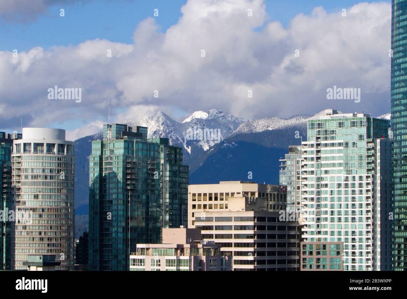 A cityscape of downtown Vancouver taken from an elevated position along Burrard Street with the north shore mountains in the background Stock Photo