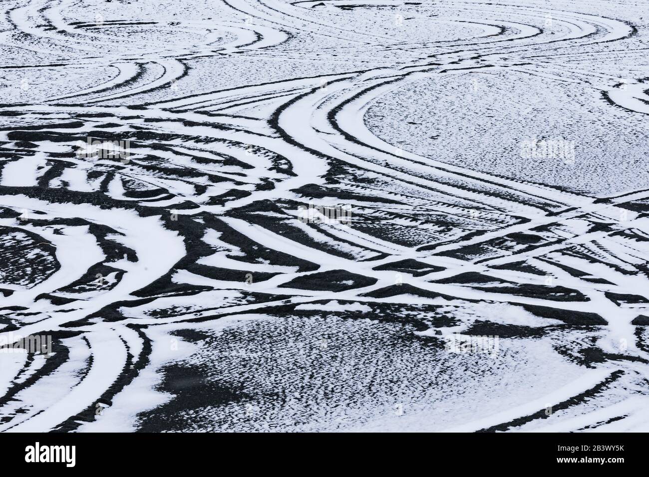 Vehicle tracks in snow-covered sand just off the road to Cape Race Lighthouse, Newfoundland, Canada Stock Photo