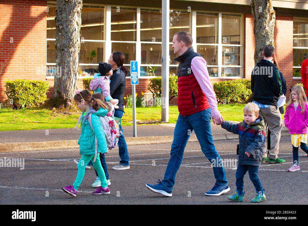 Parents walk their children to school as Lake Oswego, Oregon school