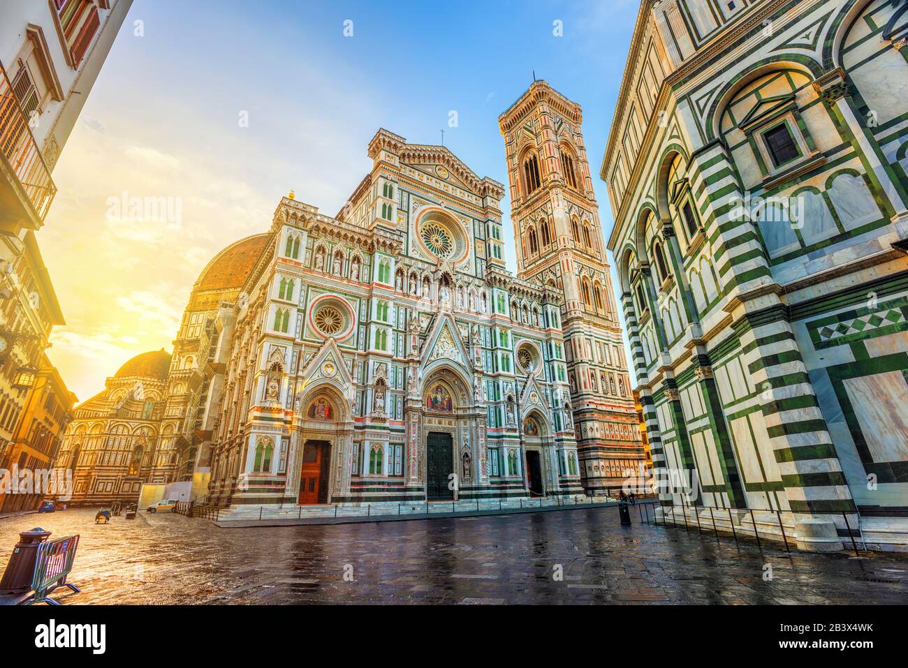 Cathedral of Santa Maria del Fiore with Brunelleschi's Dome, Giotto's Campanile and Baptisterium in Piazza del Duomo, Florence, Italy, in dramatic sun Stock Photo
