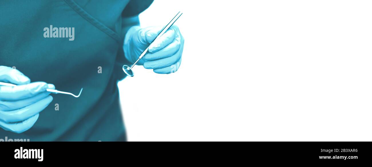 In the office of the dental clinic. The doctor holds tools for ...
