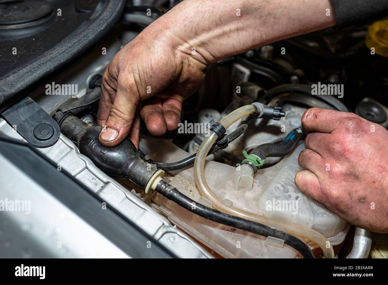 The mechanic bleeds the fuel system with a pump that is on the fuel