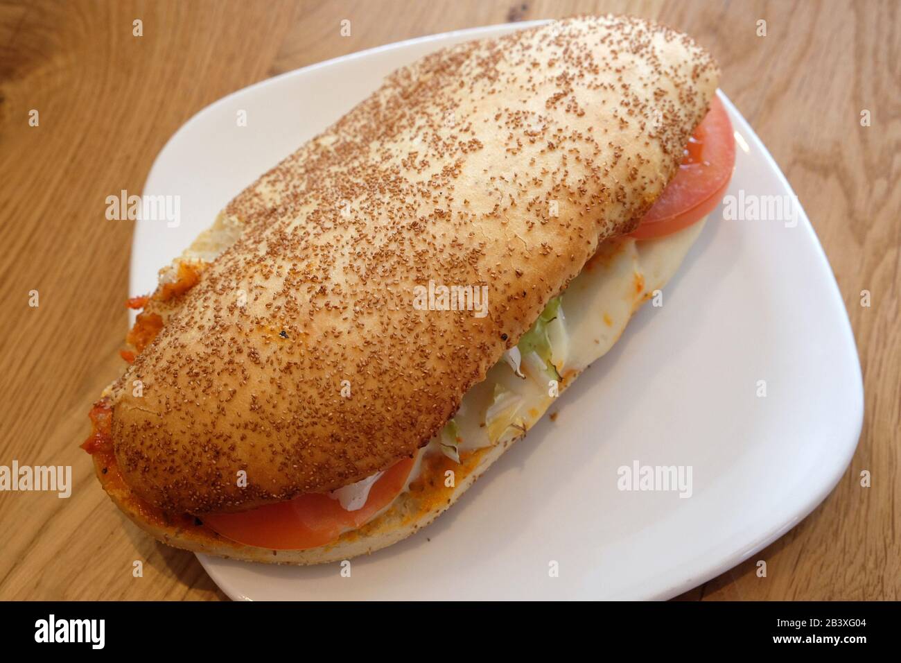 Whole wheat bread roll with tomato and mozzarella Stock Photo