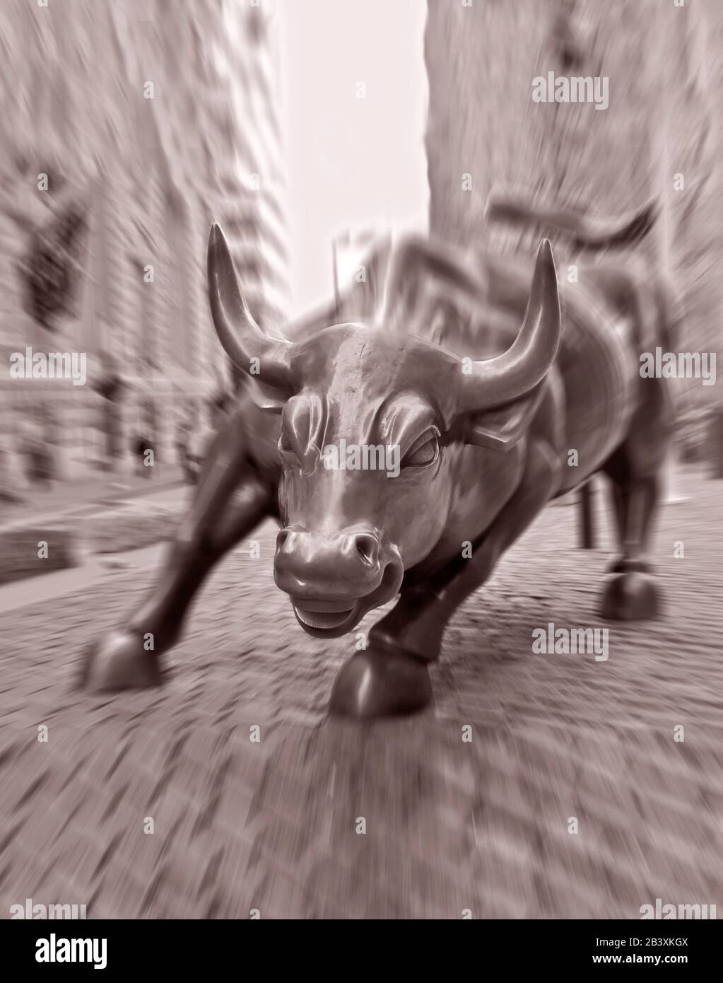The Wall Street Bull in Lower Manhattan, New York, USA. Large Bronze sculpture by Arturo Di Modica. Photograph with motion, Bull's face is sharp Stock Photo