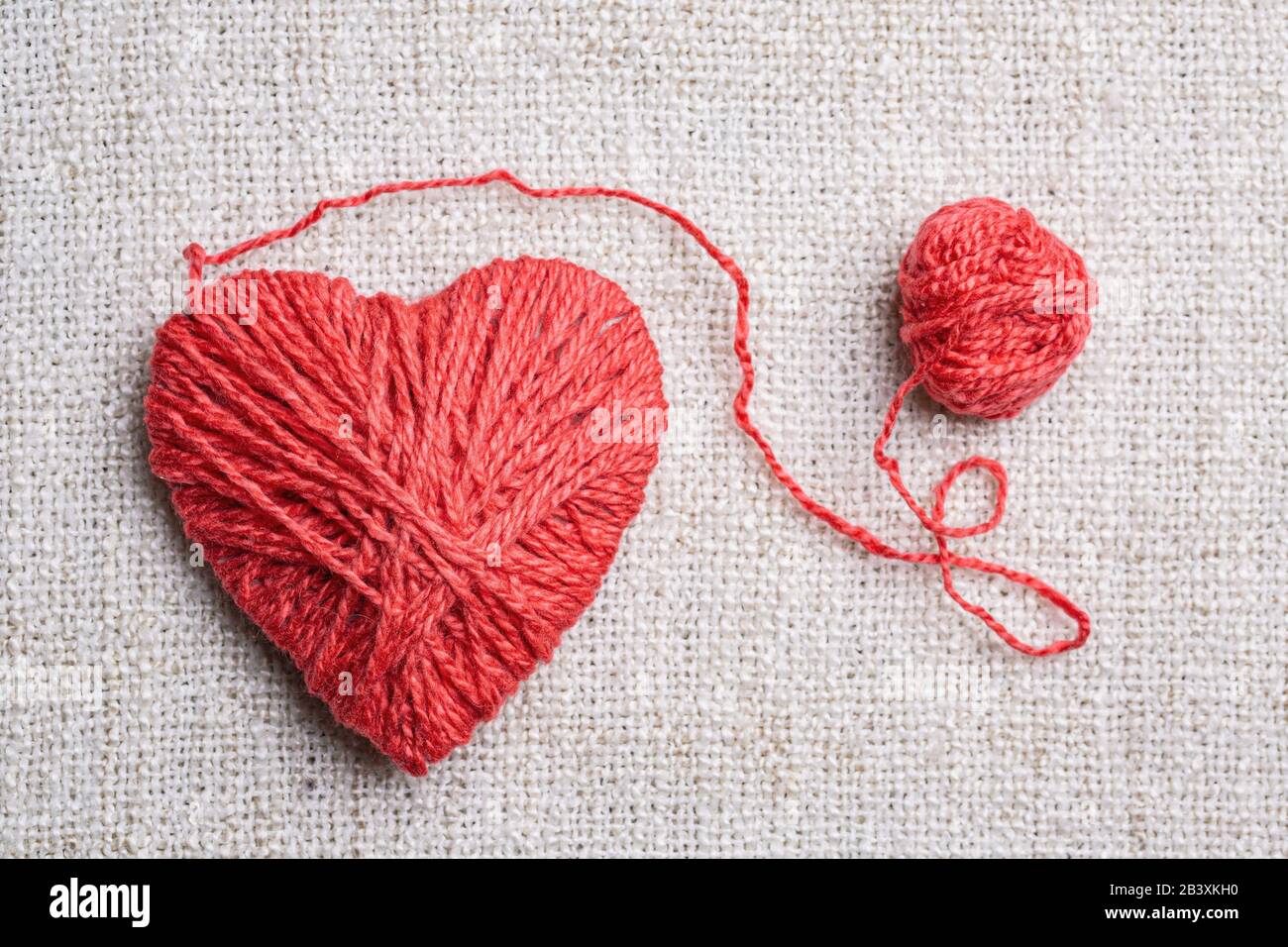 Red heart shape symbol made from wool Stock Photo
