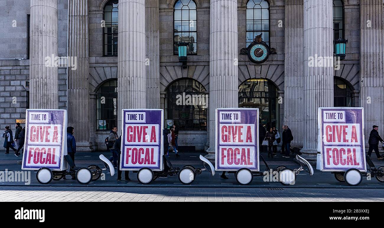 Outside the General Post Office in O'Connell Street, Dublin, Ireland,  posters encouraging greater use of the Irish language-give a focal(word) Stock Photo