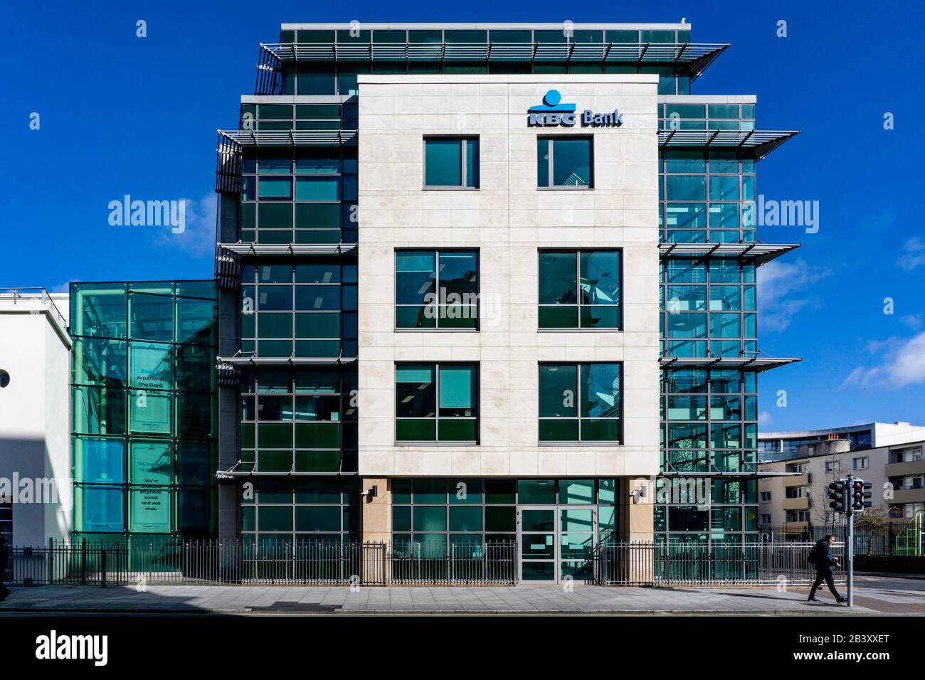 KBC Bank.A man passing the head office of KBC Bank in Sandwith Street, Dublin, Ireland. KBC Bank Ireland provides a wide range of banking services. Stock Photo