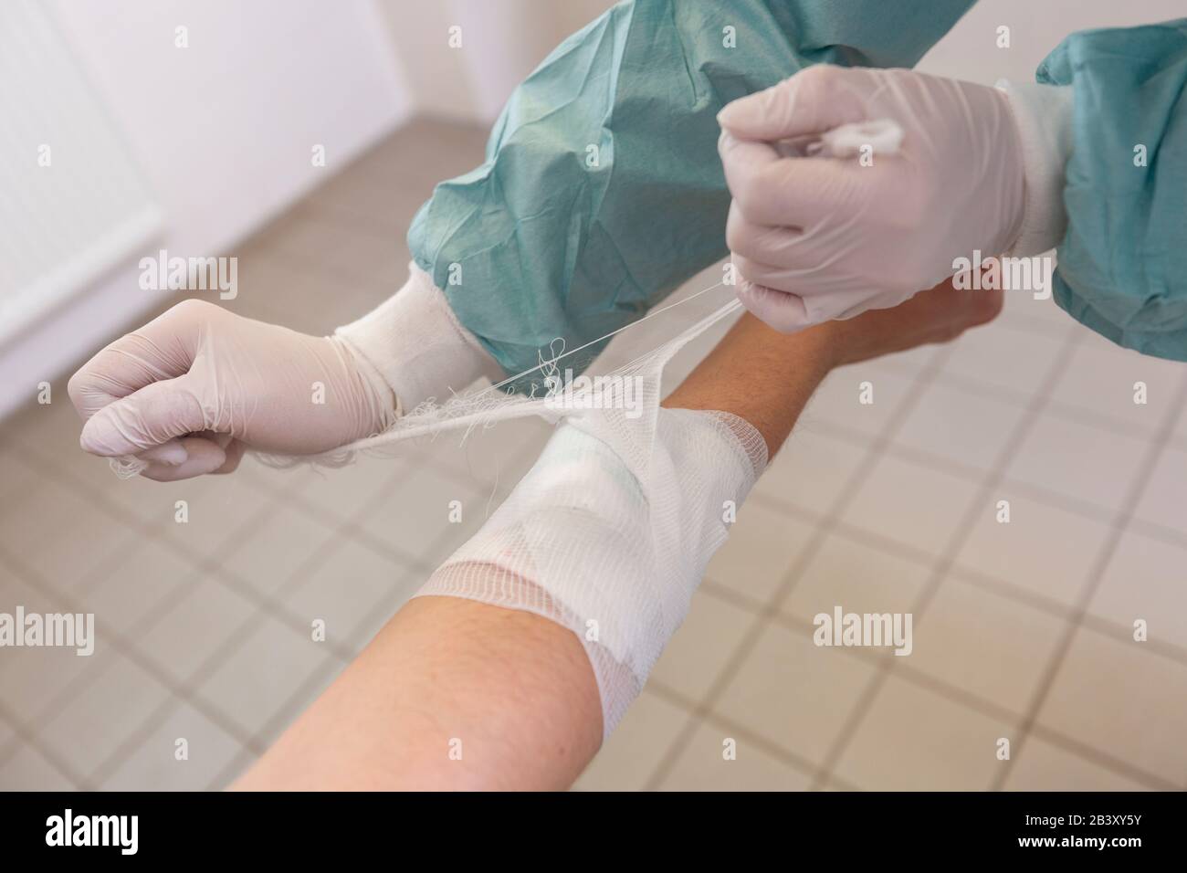 A doctor puts on a pressure bandage in a hospital Stock Photo Alamy