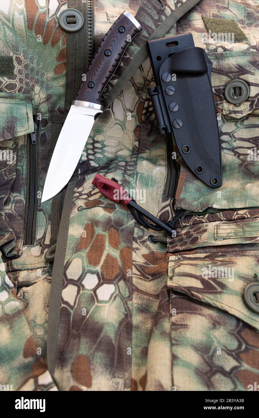 Hunting knife and flint for a fire. Hunting camouflage Stock Photo Alamy
