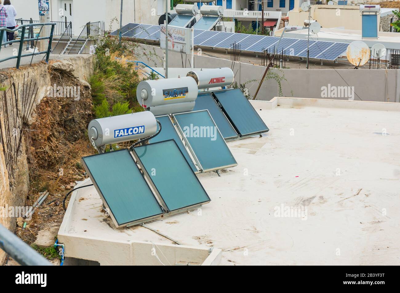 Bali, Crete, Greece -10.09.2019: solar water heaters on the roofs of houses. Stock Photo