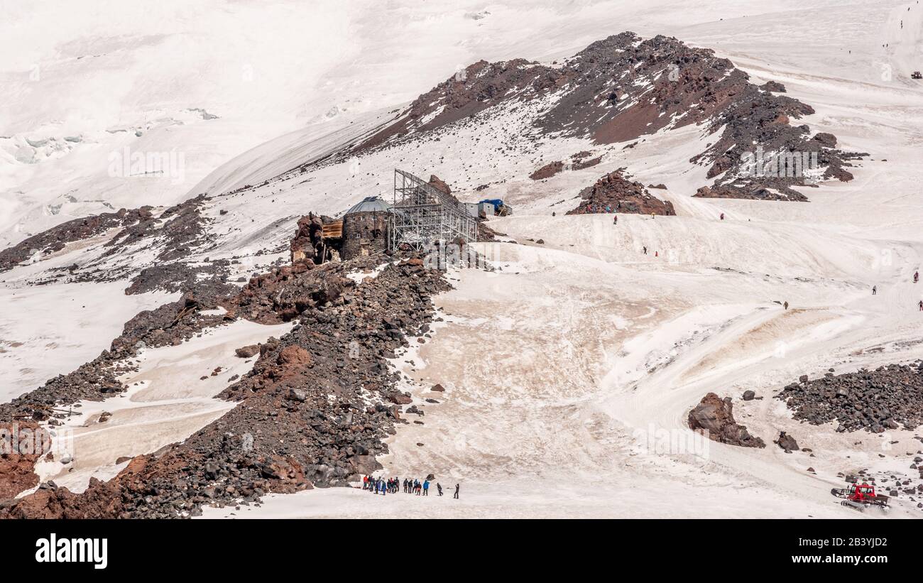 Landscape view of Diesel Hut.The highest building in Mount Elbrus, Caucasus, Russia.  Groups of alpinists practices at the bottom. Stock Photo