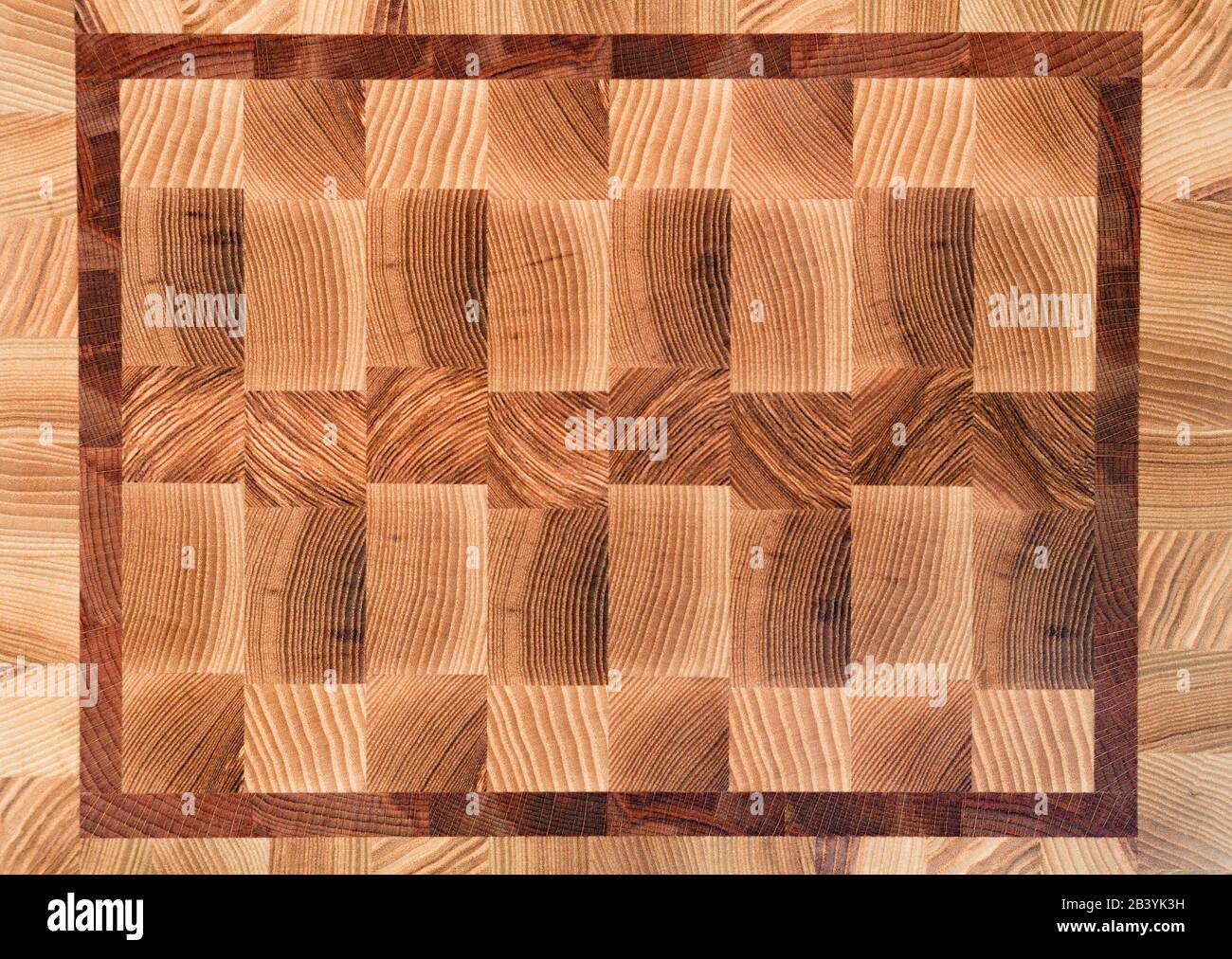 Wooden butcher chopping block, natural end wood board texture background pattern close up. Stock Photo