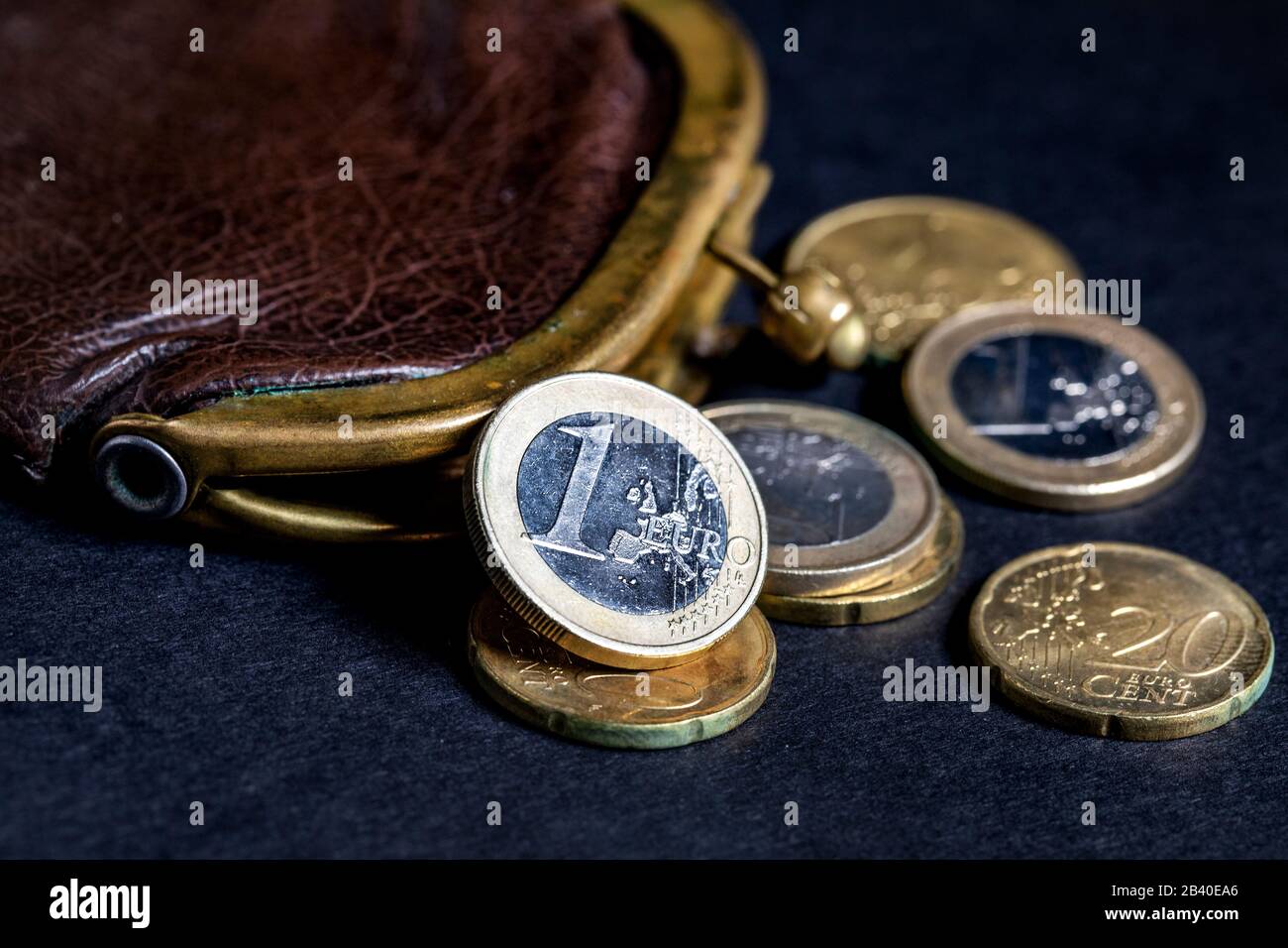 old wallet and Euro coins on a dark background Stock Photo