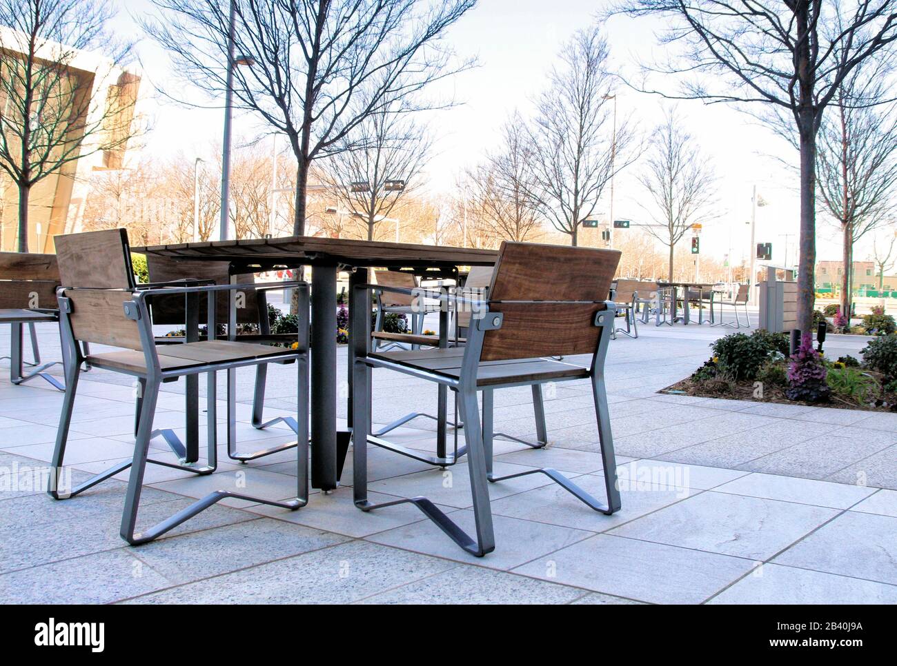 A view of outdoor restaurant table and chairs in the foreground with Myriad Gardens in the background. Stock Photo