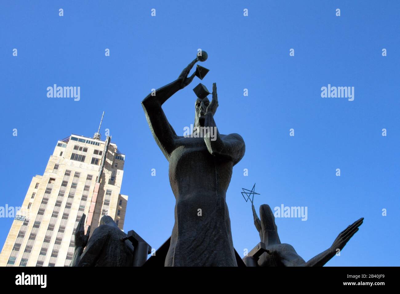 A wide angle distorted view of the relocated series of sculptures standing outside the Oklahoman headquarters in Downtown Oklahoma City. Stock Photo