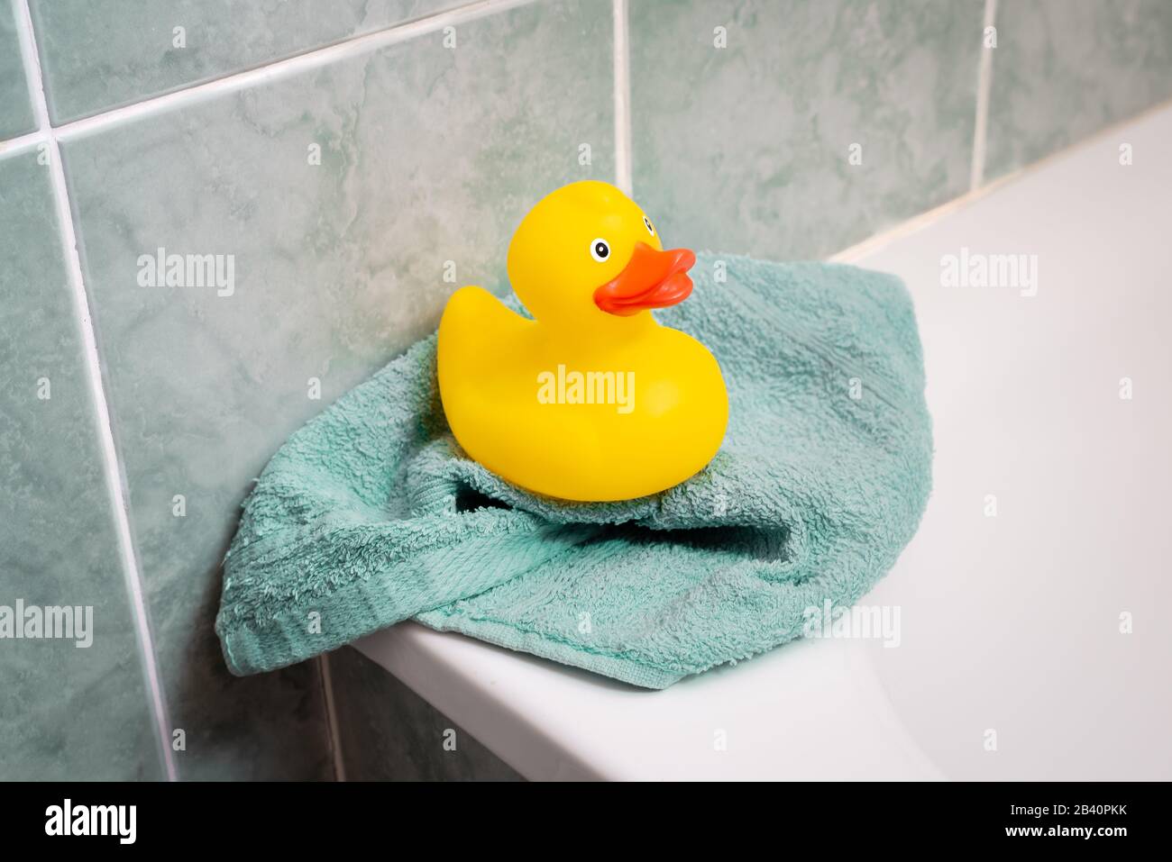 Yellow rubber duck in the bathtub with a towel Stock Photo Alamy