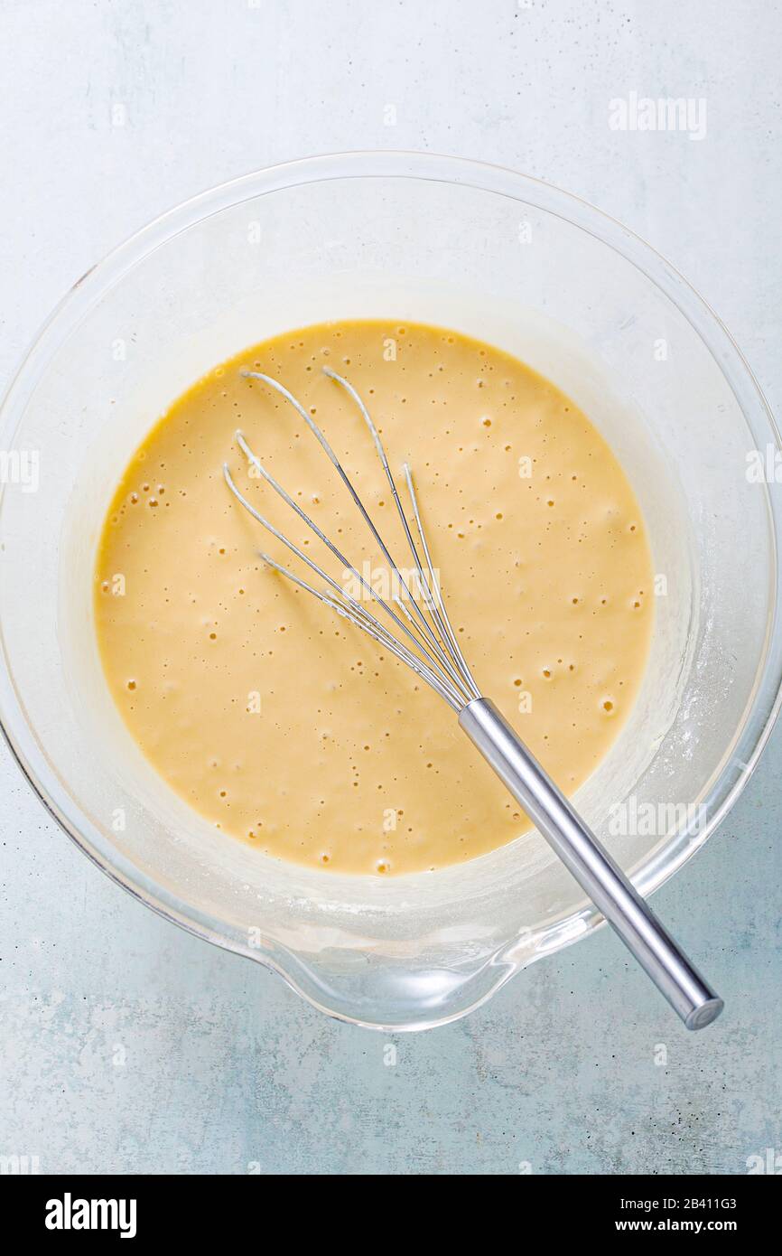 ready batter in a glass bowl for frying vegetables in oil Stock Photo