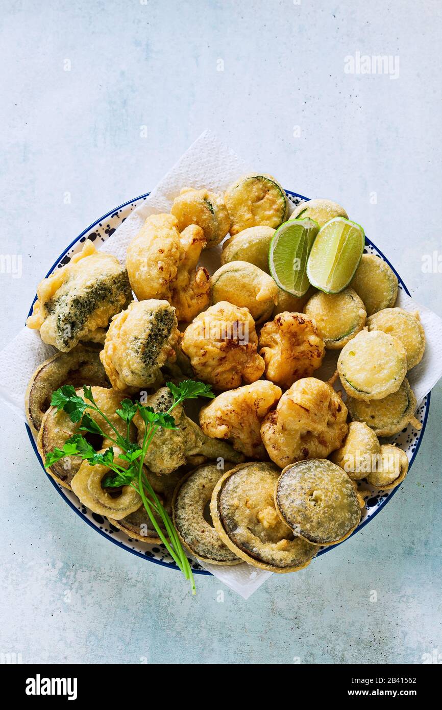 Deep frying vegetables in a plate on the table. vegan option Stock Photo Alamy