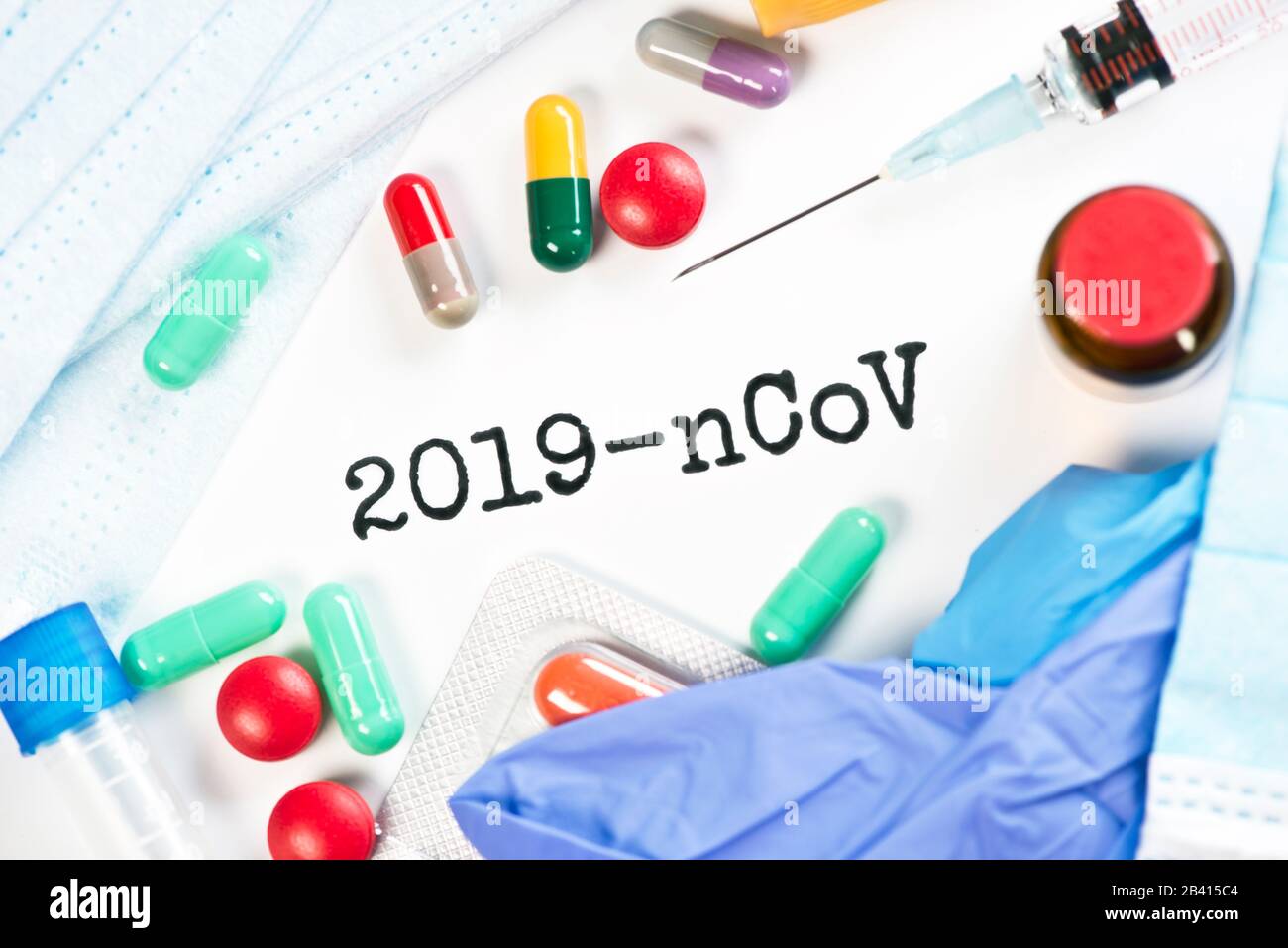 Corona virus 2019-nCoV text concept with gloves, masks, syringe vial and various medications.. Stock Photo