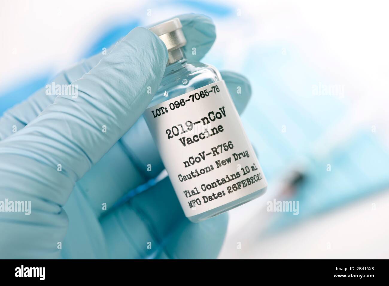 Corona virus 2019-nCoV vaccine vial in gloved hand of nurse with syringe and mask. Stock Photo